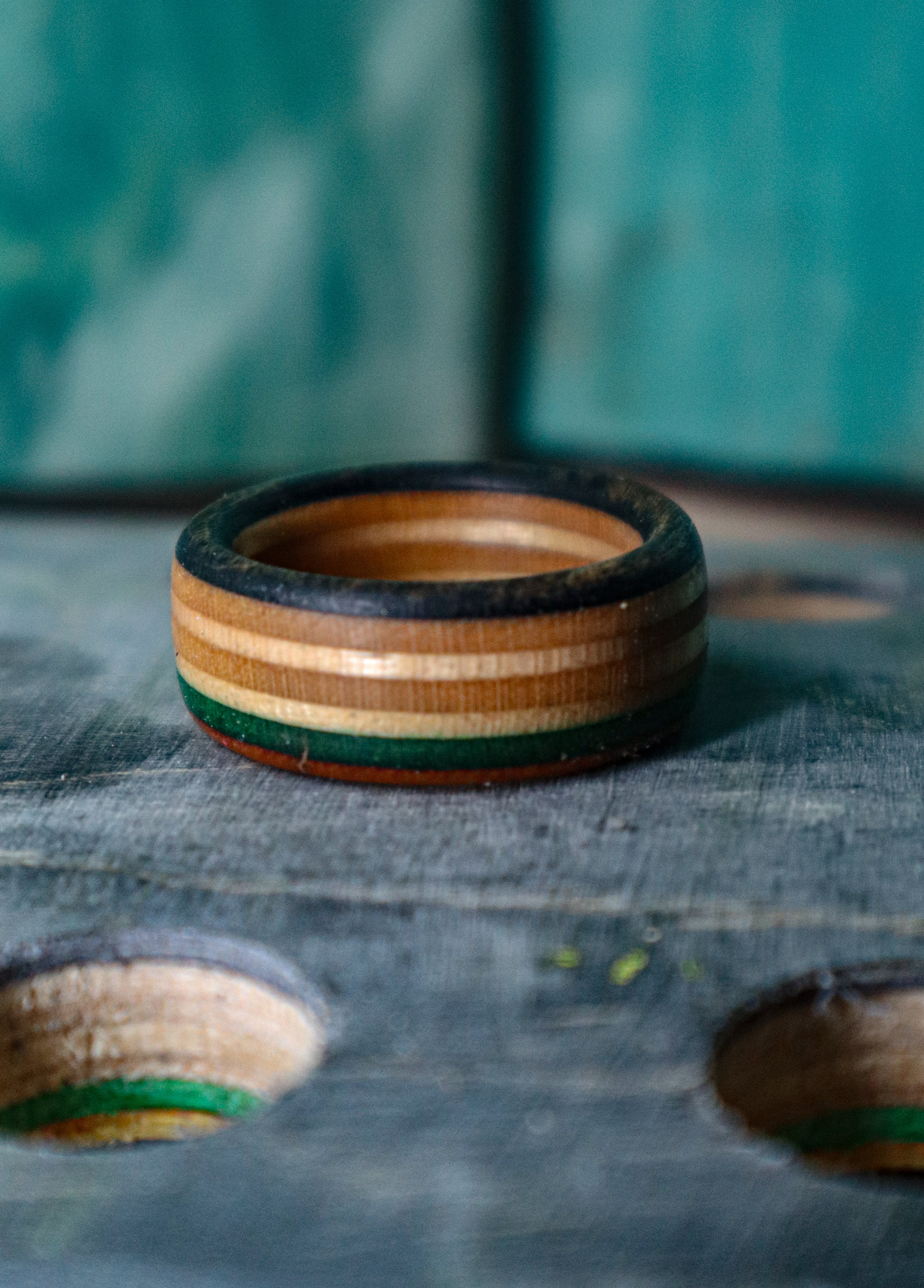 Three handcrafted recycled skateboard rings — Bayshore Rings finished products